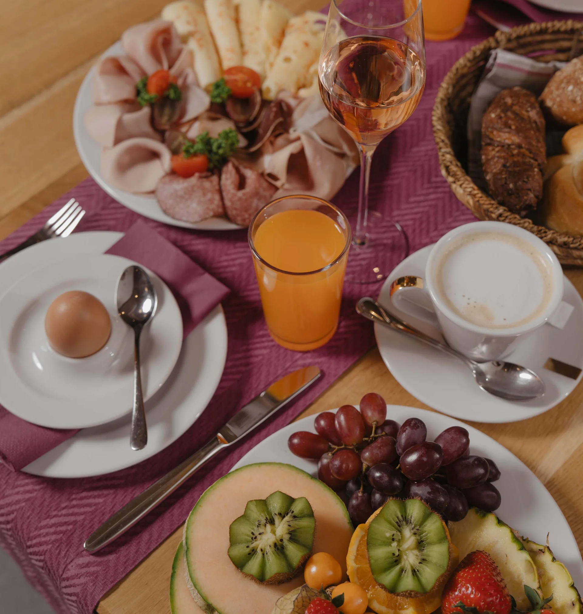 Ferienglück and Alpenland | Your stylish hotels in Ischgl Breakfast table with cold cuts, bread, fruit, eggs, juice and coffee