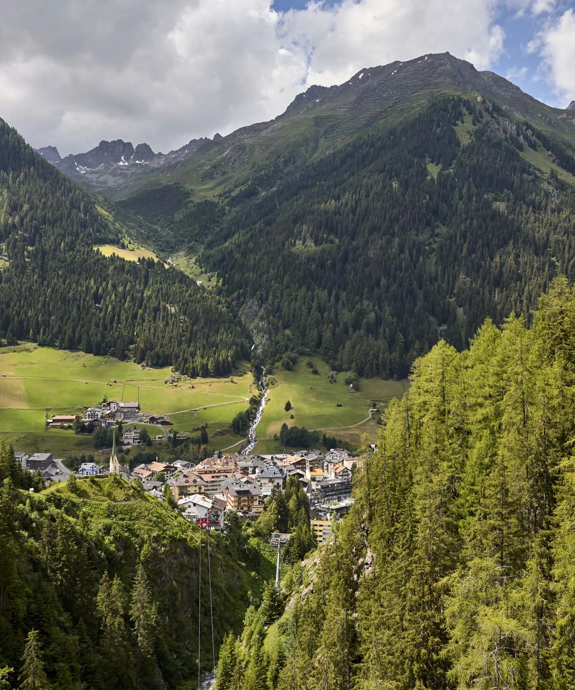 Ferienglück and Alpenland | Your stylish hotels in Ischgl Mountain village in a green valley surrounded by forested slopes and high peaks